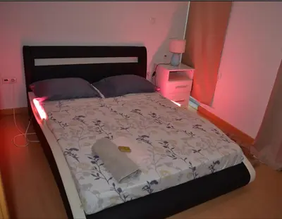 a bedroom with a bed with a light on it at Domingas in Praia