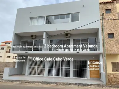 a white building with a sign on the side of it at Paradise Cape Verde in Santa Maria