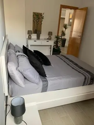 a white bed with pillows on it in a bedroom at Paradise Cape Verde in Santa Maria