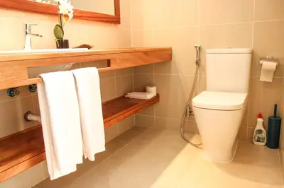a bathroom with a toilet and a sink and towels at Mister Barracuda in Santa Maria