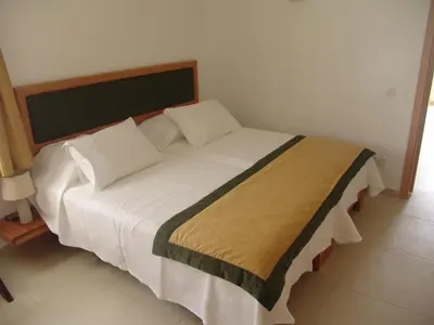 a bed with white sheets and pillows in a room at Mister Barracuda in Santa Maria