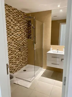 a bathroom with a shower and a toilet and a sink at Ocean View Stay in Mindelo