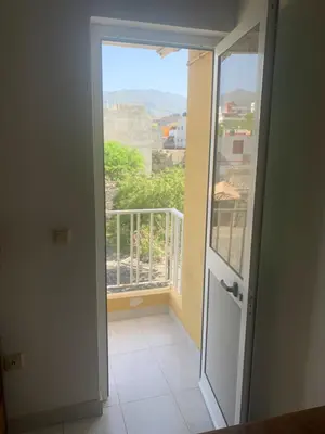 a door leading to a balcony with a view at Residencial Pôr do Sol in Porto Novo