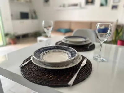 a table with plates and glasses on a table at More then a beautiful apart The real Morabeza Capeverdean hospitality in Santa Maria