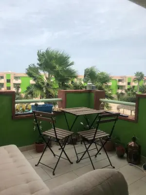 a patio with a table and chairs on a balcony at More then a beautiful apart The real Morabeza Capeverdean hospitality in Santa Maria