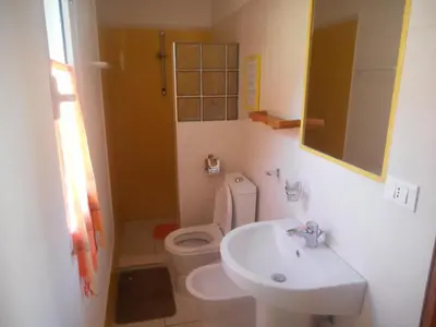 a small bathroom with a toilet and a sink at Pousada do Ceu in Paul