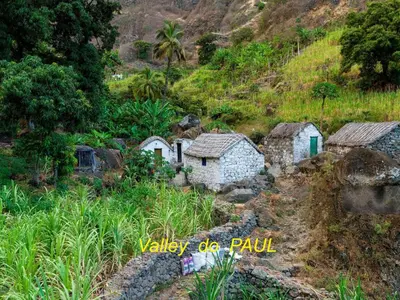 a group of small stone buildings on a hill at Pousada do Ceu in Paul