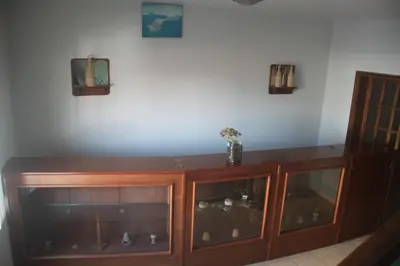 a wooden cabinet with glass doors in a room at Hotel Avenida in Assomada