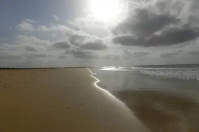 a beach with the sun shining on the water at Kasa Mona in Calheta Do Maio