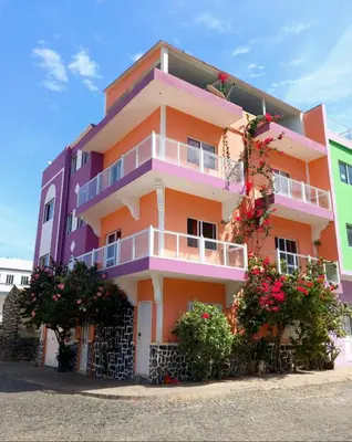 a colorful building with flowers in front of it at Casa Celeste in Ponta do Sol