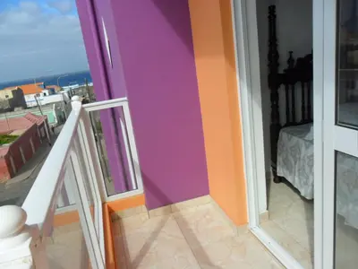a view of a balcony with a purple and orange wall at Casa Celeste in Ponta do Sol