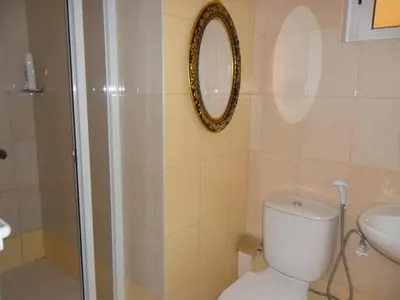 a bathroom with a toilet and a sink and a mirror at Casa Celeste in Ponta do Sol
