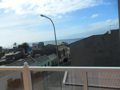 a balcony with a street light and some buildings at Casa Celeste in Ponta do Sol
