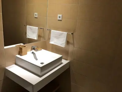 a bathroom with a white sink and a mirror at Harmony apartment in Mindelo São Vicente in Mindelo