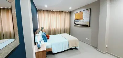 a hotel room with a bed and a mirror at kelly's House Plateau City Center in Praia