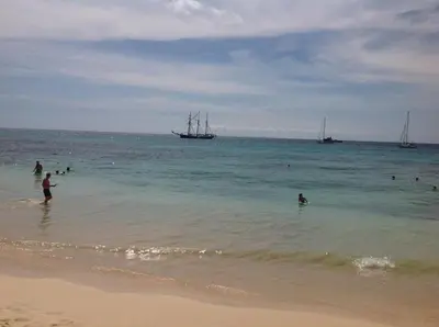 a group of people in the water at the beach at Apt71 Porto Antigo 2 in Santa Maria