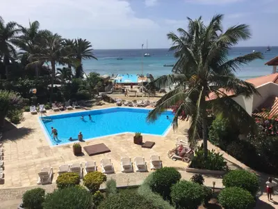 an overhead view of a pool with the ocean in the background at Apt71 Porto Antigo 2 in Santa Maria