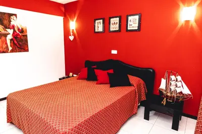 a red bedroom with a bed with a red wall at Criola Vistamar in Mindelo