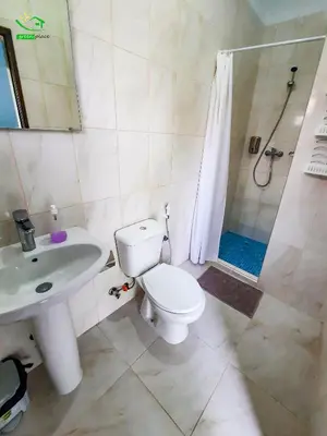 a bathroom with a toilet and a sink and a shower at Pousada Green Place in Ribeira Grande