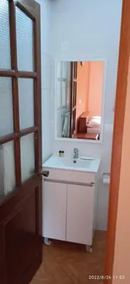 a bathroom with a sink and a mirror at Damontanha 2 in Ribeira Grande