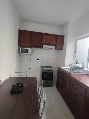 a kitchen with a wooden table and a stove at Apartamento Coral in Santa Maria
