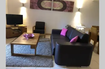 a living room with a couch and a coffee table at Schönes, ruhiges und geräumiges Apartment mit Poolanlage in der Nähe von Santa Maria in Prainha