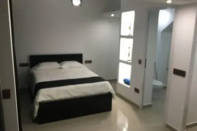 a bedroom with a bed and a bathroom at Studio GARAGE in Mindelo