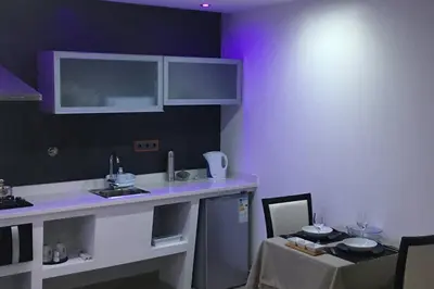a kitchen with a counter and a sink and a table at Studio GARAGE in Mindelo