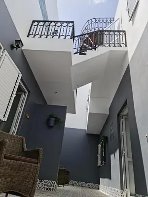 a building with a balcony with a stair case at Deluxe B&B 