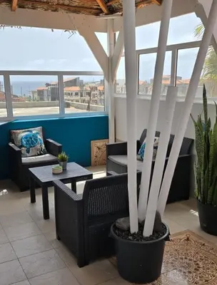 a patio with chairs and a table and some plants at Deluxe B&B 