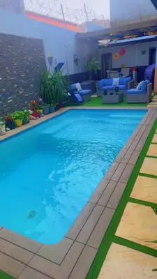 a swimming pool at a hotel with blue water at YOUR HOME AWAY FROM HOME in Praia