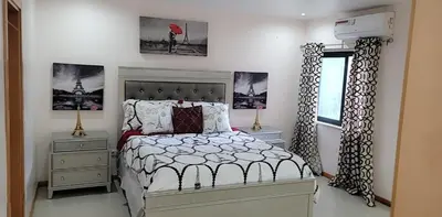 a bedroom with a bed and a window at YOUR HOME AWAY FROM HOME in Praia