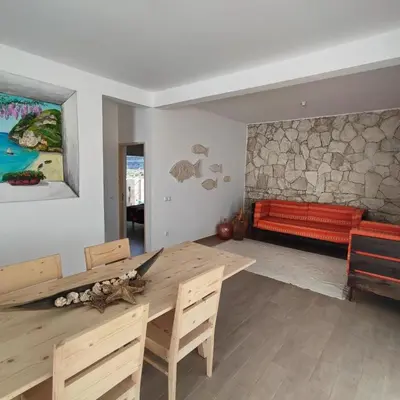 a living room with a wooden table and a couch at Casa Djarmai Apartments in Vila do Maio
