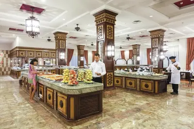 a group of people preparing food in a buffet at Hotel Riu Funana - All Inclusive in Santa Maria