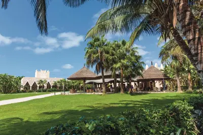 a view of a resort with palm trees at Hotel Riu Funana - All Inclusive in Santa Maria
