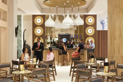 a group of people sitting at tables in a restaurant at Hotel Riu Cabo Verde - Adults Only - All Inclusive in Santa Maria
