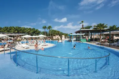 a large pool with people in the water at a resort at Hotel Riu Cabo Verde - Adults Only - All Inclusive in Santa Maria