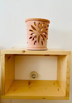 a pink pot sitting on top of a wooden shelf at Ca' Santa Barbara, Free Wi-fi, Sea view, Sal Rei, Boa Vista, Cape Verde in Sal Rei