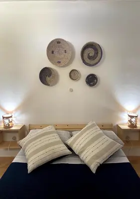 a bedroom with a bed with plates on the wall at Ca' Santa Barbara, Free Wi-fi, Sea view, Sal Rei, Boa Vista, Cape Verde in Sal Rei