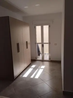 an empty room with doors and a tiled floor at Comfortable and spacious apartment with ocean views of Cabral beach in Sal Rei