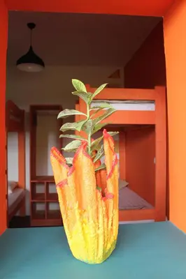 a plant in a vase sitting on top of a table at THE RETREAT in Monte Joana