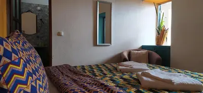 a hotel room with a bed and a chair at THE RETREAT in Monte Joana