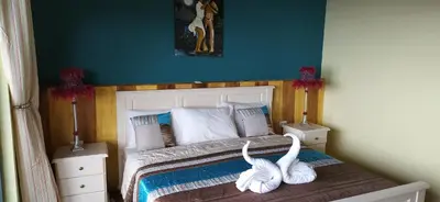 a bedroom with a bed with two white swans on it at THE RETREAT in Monte Joana