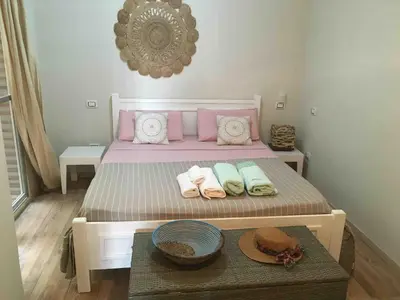 a bed with towels and a table in a room at KatlantiK Ca Madeira Deluxe in Sal Rei