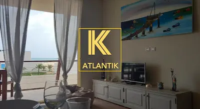 a living room with a table and a tv and a window at KatlantiK Ca Madeira Deluxe in Sal Rei