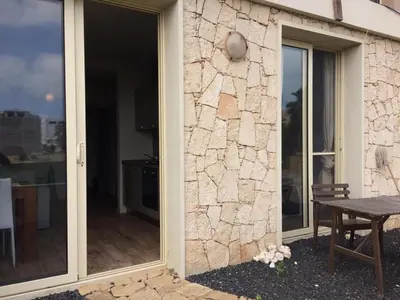 a sliding glass door leading to a patio with a table at KatlantiK Ca Madeira Deluxe in Sal Rei