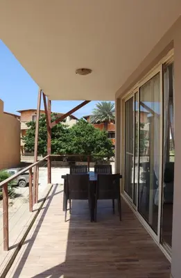 a patio with a table and chairs on a deck at KatlantiK Ca Madeira Deluxe in Sal Rei