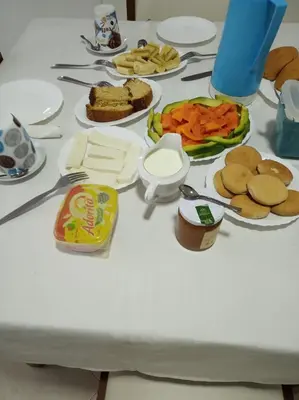 a white table with plates of food on it at Casa Familiar Gilda in Ribeira Grande