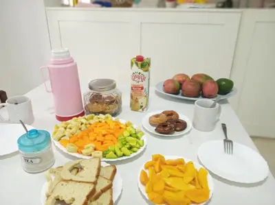 a table topped with plates of food and fruit at Casa Familiar Gilda in Ribeira Grande