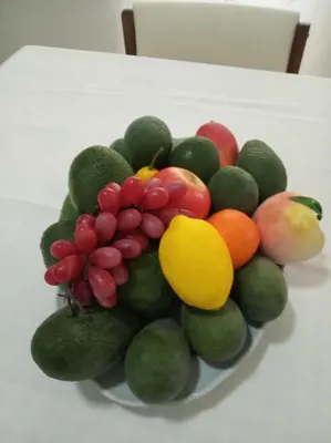 a bowl of fruit sitting on a table at Casa Familiar Gilda in Ribeira Grande